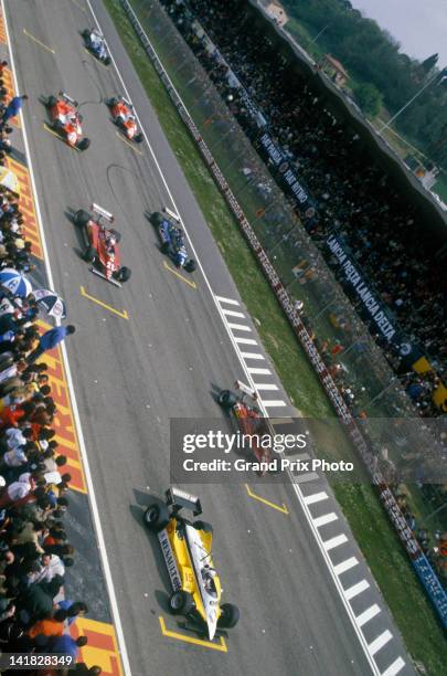 Gilles Villeneuve and Didier Pironi aboard their Scuderia Ferrari 126CK Ferrari V6s await the start behind Alain Prost on pole position in the Equipe...