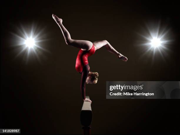 female gymnast on balancing beam. - reflector stock pictures, royalty-free photos & images