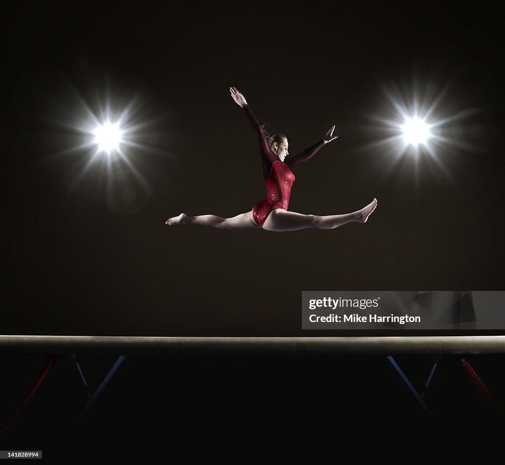Female Gymnast Doing Mid Air Splits
