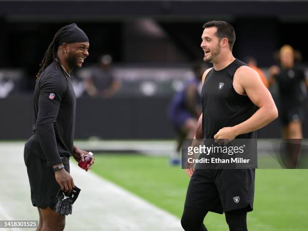 Wide receiver Davante Adams and quarterback Derek Carr of the Las Vegas Raiders warm up before a preseason game against the New England Patriots at...