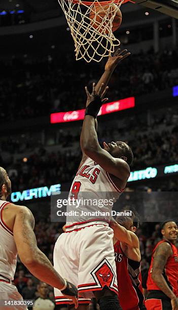 Loul Deng of the Chicago Bulls puts up the game-winning shot against the Toronto Raptors at the United Center on March 24, 2012 in Chicago, Illinois....