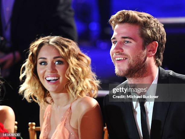 Actress/singer Miley Cyrus and actor Liam Hemsworth in the audience during Muhammad Ali's Celebrity Fight Night XVIII held at JW Marriott Desert...