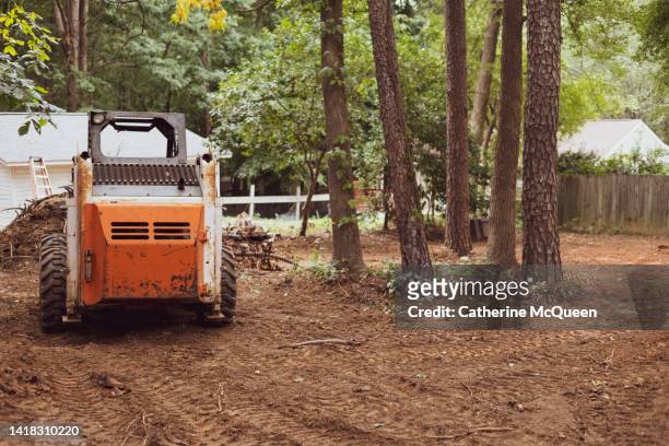 skid steer loader used for earth moving landscaping on recently cleared land - land clearing stock pictures, royalty-free photos & images