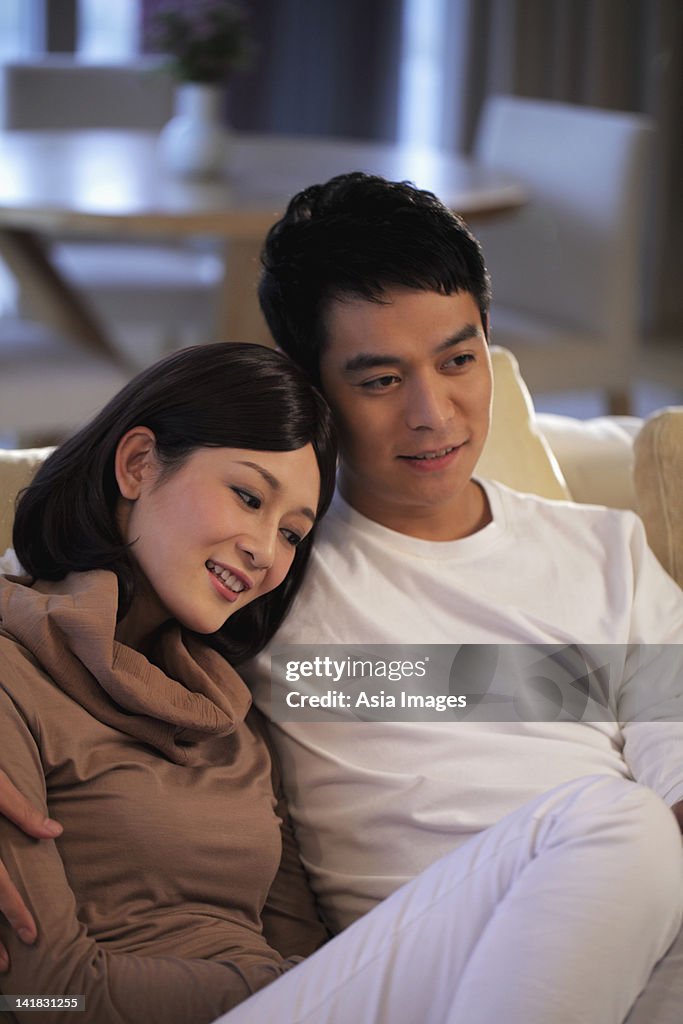 Young couple sitting on sofa together