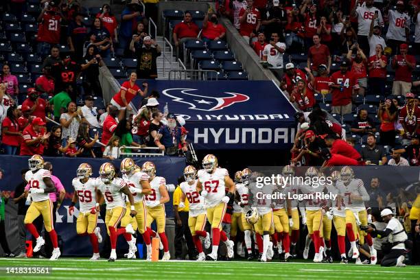 The San Francisco 49ers run onto the field during a preseason game against the Houston Texans at NRG Stadium on August 25, 2022 in Houston, Texas.