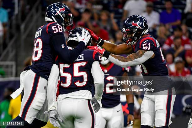 Jerry Hughes celebrates with Christian Kirksey and Kamu Grugier-Hill of the Houston Texans after sacking Trey Lance of the San Francisco 49ers during...