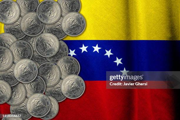 bolívares cash coins and venezuela flag - venezuela flag stock pictures, royalty-free photos & images