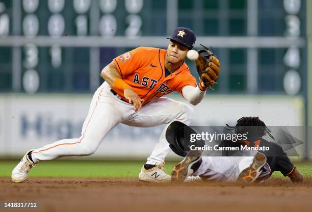 Jeremy Pena of the Houston Astros unable to tag out Cedric Mullins of the Baltimore Orioles during the third inning at Minute Maid Park on August 26,...