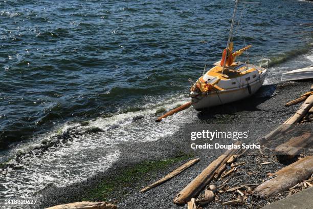 abandoned sailboat washed up on the shore - coastal deprivation stock pictures, royalty-free photos & images