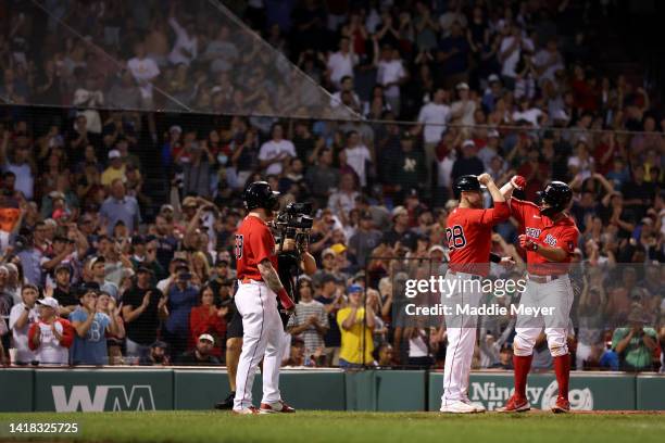 Xander Bogaerts of the Boston Red Sox celebrates with J.D. Martinez after hitting a three run home run against the Tampa Bay Rays during the sixth...