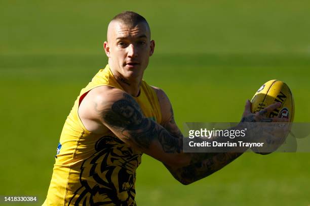 Dustin Martin of the Tigers gathers the ball during a Richmond Tigers AFL training session at Punt Road Oval on August 27, 2022 in Melbourne,...