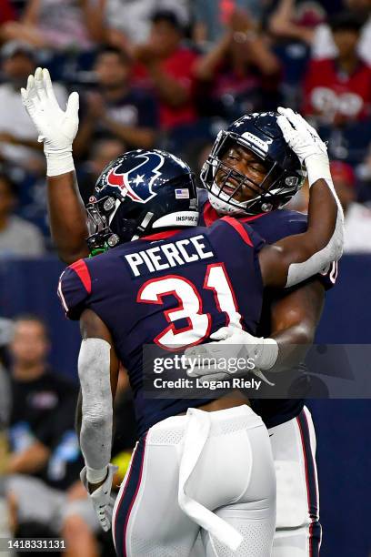 Dameon Pierce celebrates with A.J. Cann of the Houston Texans after scoring a touchdown during a preseason game against the San Francisco 49ers at...