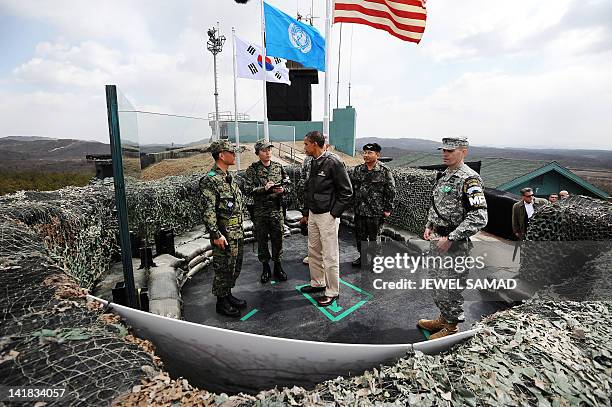 President Barack Obama listens to South Korean officers at Observation Post Ouellette during a visit to the Joint Security Area of the Demilitarized...