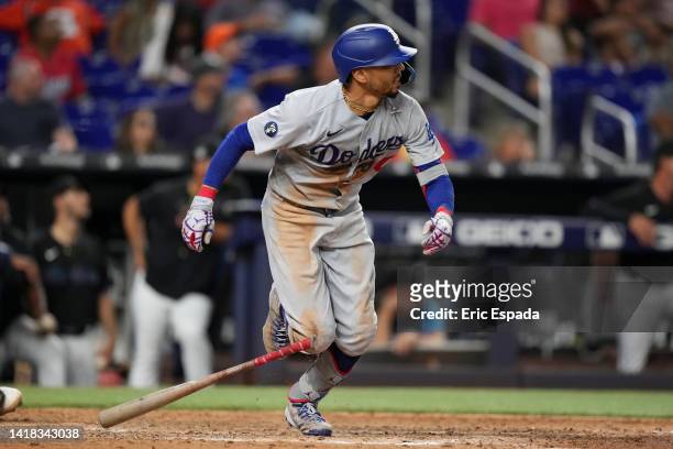 Mookie Betts of the Los Angeles Dodgers hits a double in the tenth inning against the Miami Marlins at loanDepot park on August 26, 2022 in Miami,...