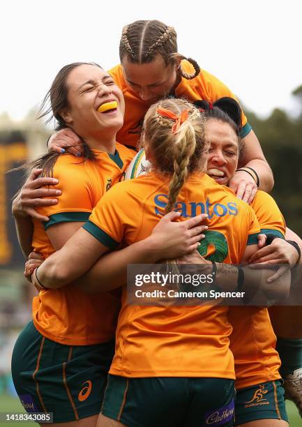 Bienne Terita of the Wallaroos celebrates scoring a try with team mates during the O'Reilly Cup match between the Australian Wallaroos and the New...