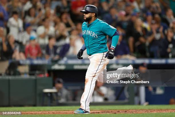 Carlos Santana of the Seattle Mariners scores against the Cleveland Guardians during the fifth inning at T-Mobile Park on August 26, 2022 in Seattle,...