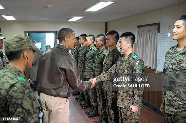 President Barack Obama greets South Korean soldiers at Observation Post Ouellette during a visit to the Joint Security Area of the Demilitarized Zone...