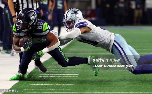 Cade Johnson of the Seattle Seahawks is forced out of bounds by Tyler Coyle of the Dallas Cowboys in an NFL preseason football game at AT&T Stadium...