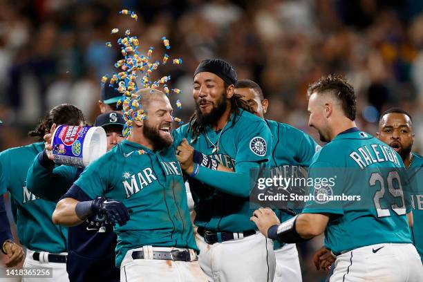 Mitch Haniger of the Seattle Mariners celebrates his walk-off single to score Dylan Moore during the eleventh inning against the Cleveland Guardians...