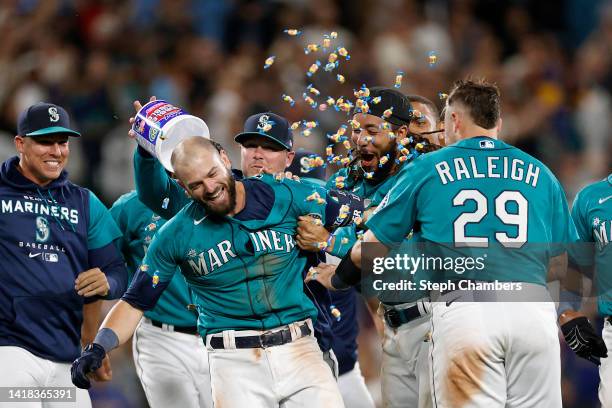 Mitch Haniger of the Seattle Mariners celebrates his walk-off single to score Dylan Moore during the eleventh inning against the Cleveland Guardians...