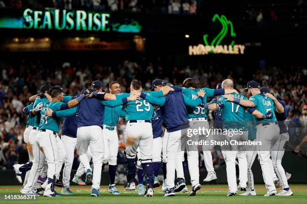 The Seattle Mariners celebrate their 3-2 win against the Cleveland Guardians during the eleventh inning at T-Mobile Park on August 26, 2022 in...