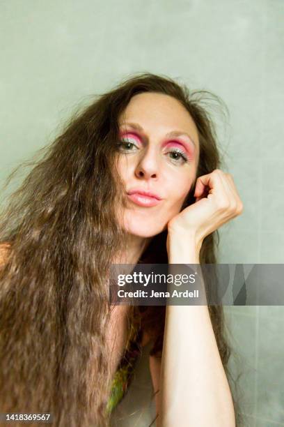 woman with attitude wearing bold makeup eyeshadow and 1980s style crimped hair long hairstyle - 1980 hair stock pictures, royalty-free photos & images