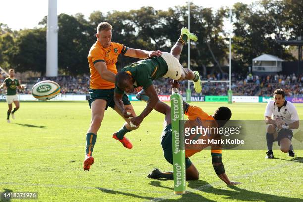 Makazole Mapimpi of the Springboks is tackled by Marika Koroibete of the Wallabies during The Rugby Championship match between the Australian...