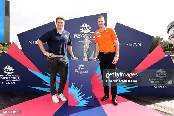 Shane Watson and Jason Behrendorff pose with the ICC T20 World Cup trophy during the ICC Men's T20 World Cup 50 Days To Go event at Optus Stadium on...
