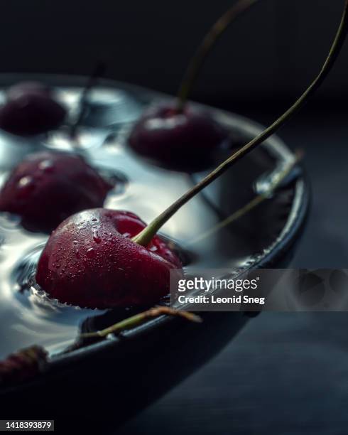 fresh cherry in bowl with water macro - cherry foto e immagini stock