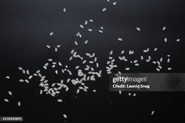 rice texture on black background - rice cereal plant stock pictures, royalty-free photos & images