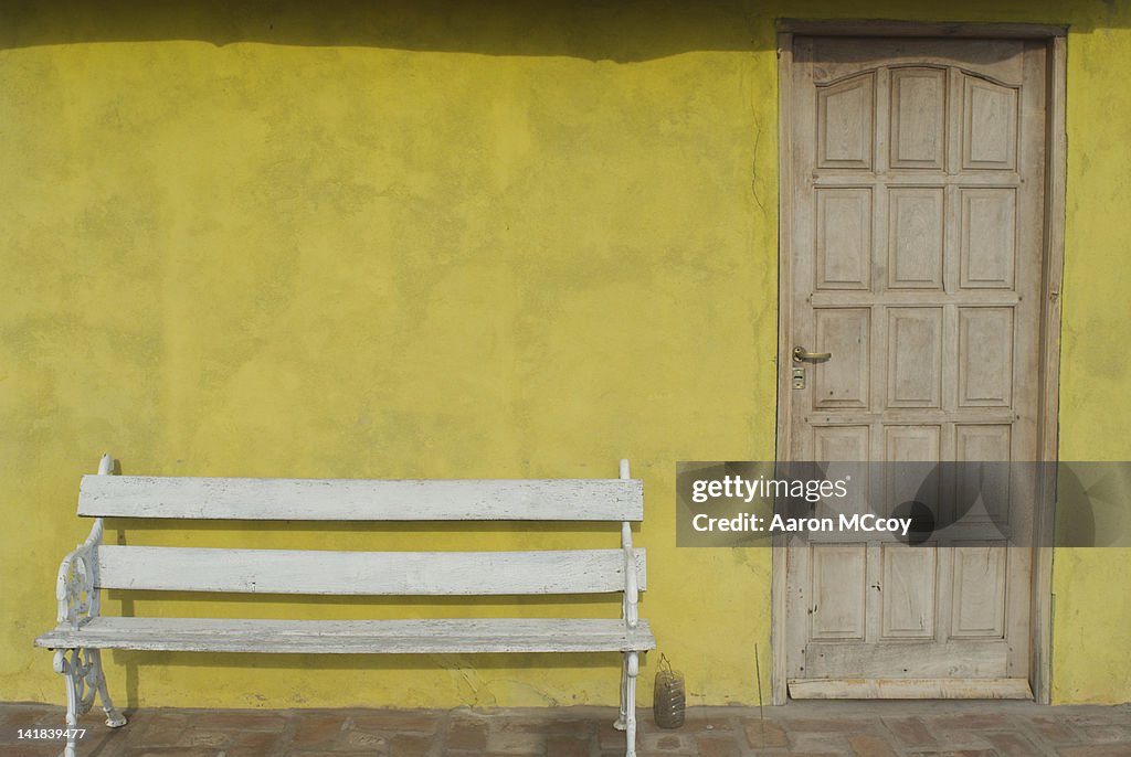 Bench next to yellow wall, Cordoba, Argentina