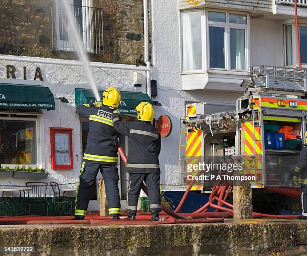 firemen putting out building fire, st ives, cornwall, england - fireman uk stock pictures, royalty-free photos & images