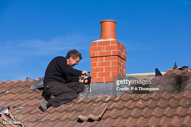 builder putting lead flashing around chimney stack - chimney stock-fotos und bilder