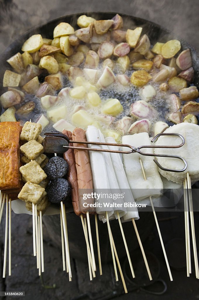 China, Yunnan Province, Lijiang, Fried potatoes and snacks on the grill