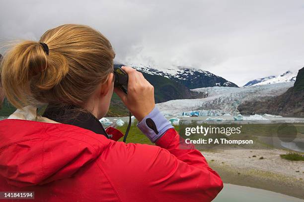 woman looking through binoculars, mendenhall glacier, juneau, alaska, usa - woman looking through ice stock pictures, royalty-free photos & images