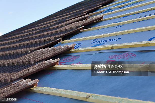 new tiled roof being built pr - material stock pictures, royalty-free photos & images