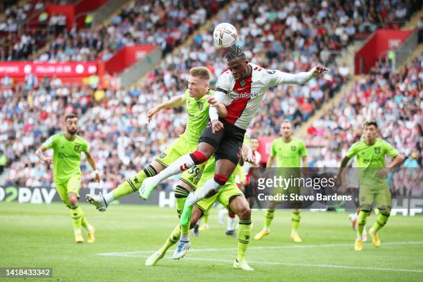 Armel Bella-Kotchap of Southampton jumps for the ball with Scott McTominay of Manchester United during the Premier League match between Southampton...