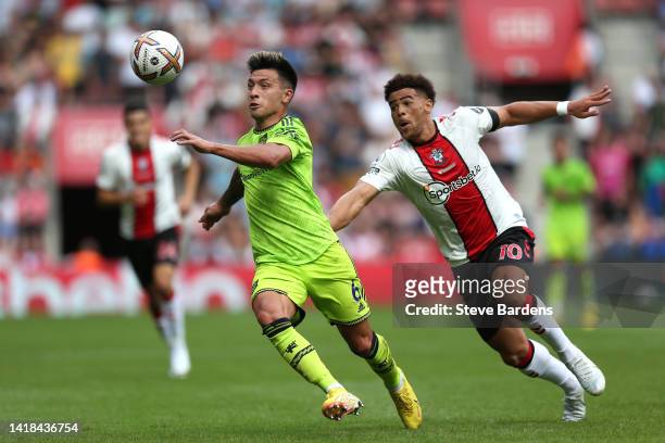 Lisandro Martinez of Manchester United is challenged by Che Adams of Southampton during the Premier League match between Southampton FC and...