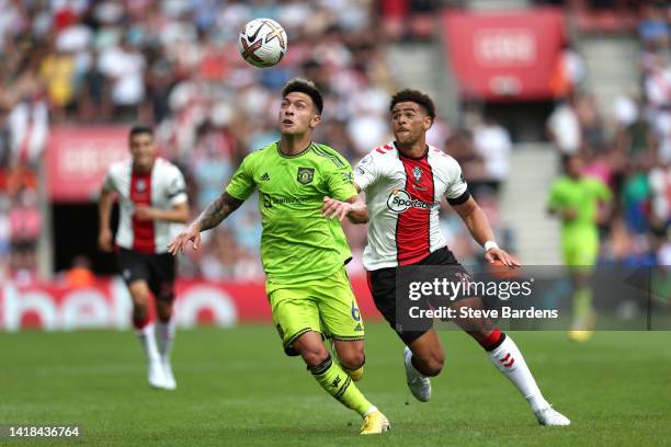 Lisandro Martinez of Manchester United is challenged by Che Adams of Southampton during the Premier League match between Southampton FC and...