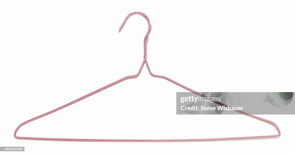 A Pink Plastic Coated Wire Clothes Hanger High-Res Stock Photo - Getty  Images