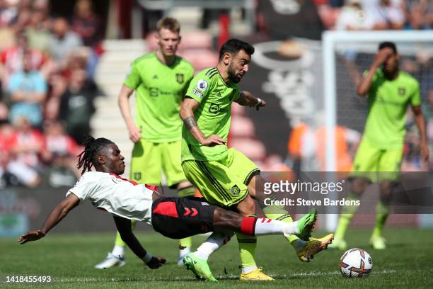Romeo Lavia of Southampton battles for possession with Bruno Fernandes of Manchester United during the Premier League match between Southampton FC...