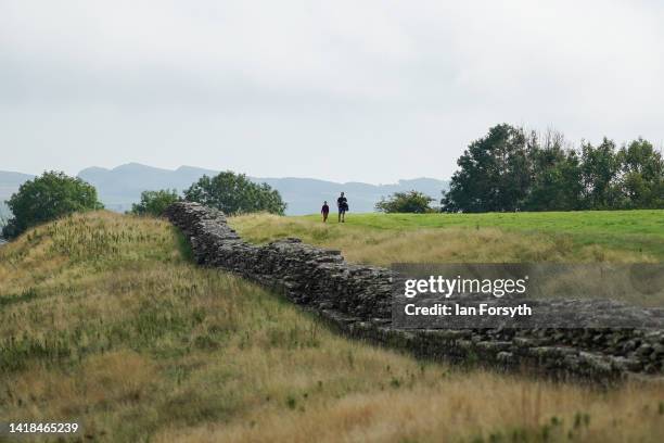 Family walk along part of Hadrian's Wall near Birdoswald Roman Fort on August 27, 2022 in Hexham, United Kingdom. 2022 is the 1900 anniversary of the...