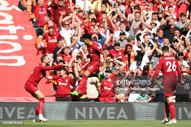 Luis Diaz of Liverpool celebrates with teammate Jordan Henderson after scoring their team's first goal during the Premier League match between...
