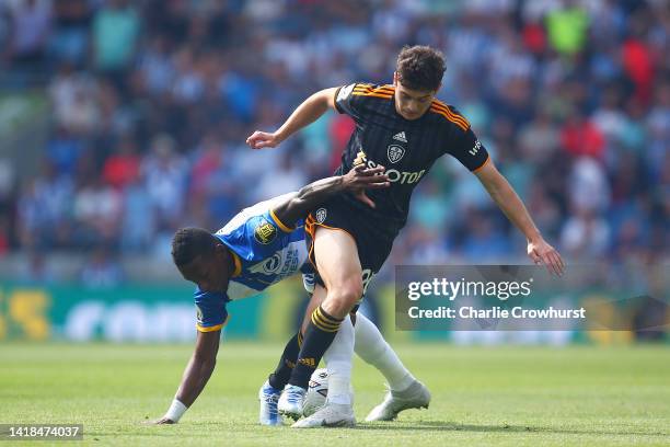 Daniel James of Leeds United is tackled by Pervis Estupiñán of Brighton & Hove Albion during the Premier League match between Brighton & Hove Albion...