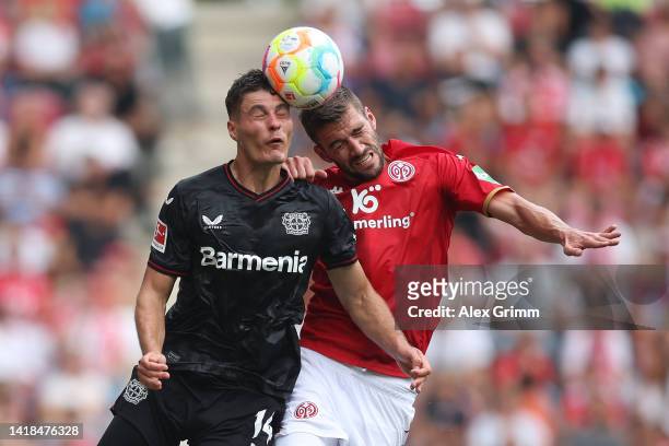 Stefan Bell of 1.FSV Mainz 05 challenges for the high ball with Patrik Schick of Bayer Leverkusen during the Bundesliga match between 1. FSV Mainz 05...