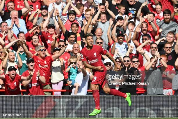 Roberto Firmino of Liverpool celebrates after scoring their team's fourth goal during the Premier League match between Liverpool FC and AFC...