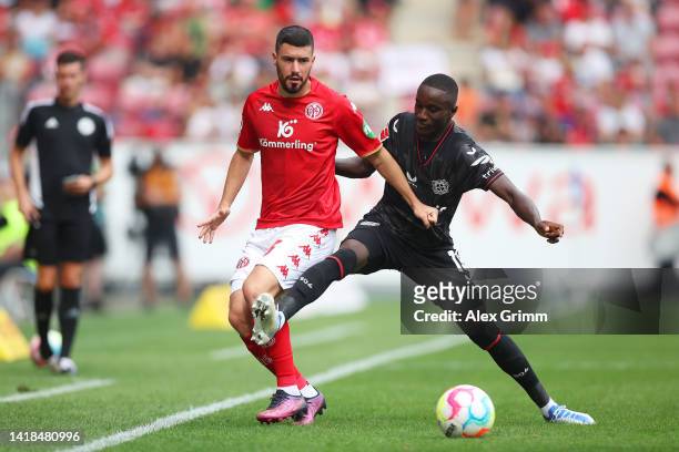 Aaron of 1.FSV Mainz 05 battles for possession with Moussa Diaby of Bayer Leverkusen during the Bundesliga match between 1. FSV Mainz 05 and Bayer 04...