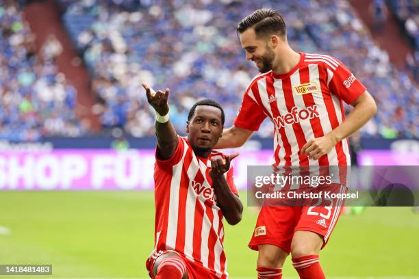 Sheraldo Becker of FC Union Berlin celebrates with teammate Niko Giebelmann after scoring their team's fourth goal during the Bundesliga match...