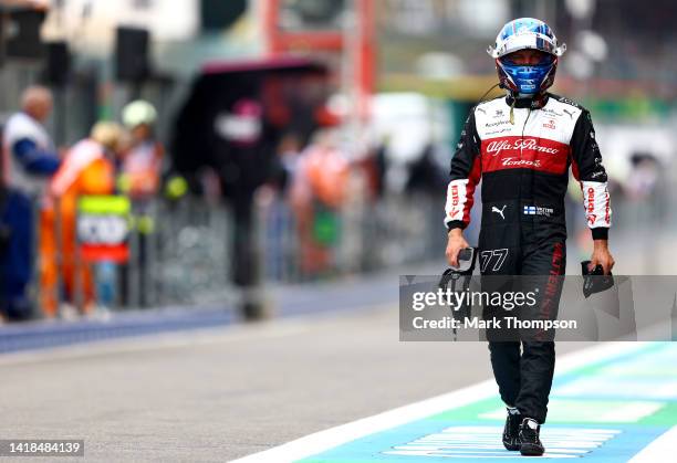 20th place qualifier Valtteri Bottas of Finland and Alfa Romeo F1 walks in the Pitlane during qualifying ahead of the F1 Grand Prix of Belgium at...