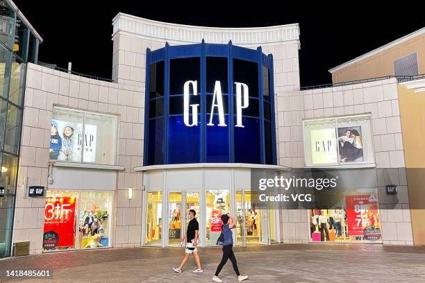 People walk by a Gap retail store on August 24, 2022 in Beijing, China.